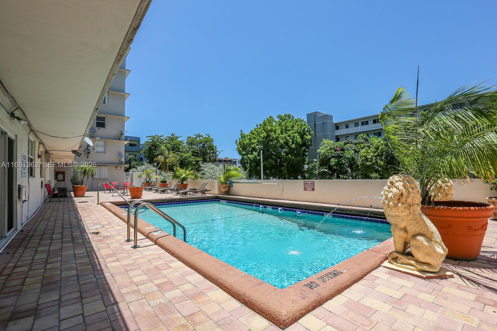 1300 Lincoln Road, Unit A701 Miami Beach, FL 33139 - Photo 21 of 36 a view of a swimming pool with sitting area