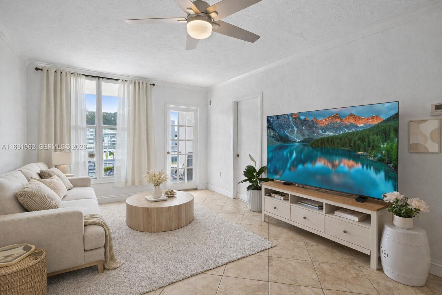 1300 Lincoln Road, Unit A701 Miami Beach, FL 33139 - Photo 3 of 36 a living room with furniture and a flat screen tv