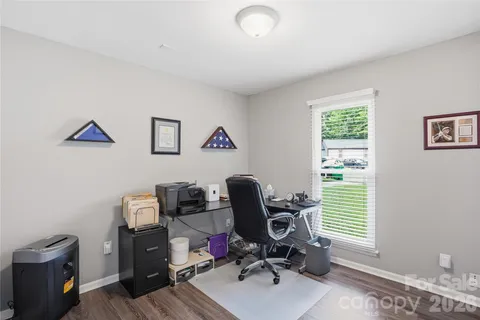 a view of workspace with wooden floor windows