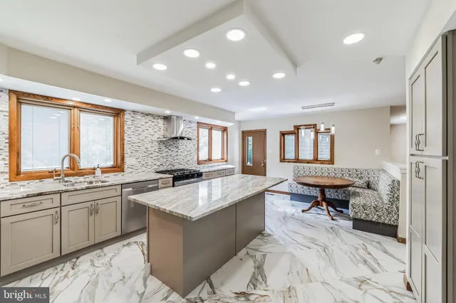 a kitchen with stainless steel appliances granite countertop a sink and stove