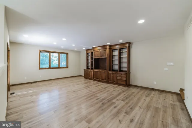 a dining room with a wooden table and chairs