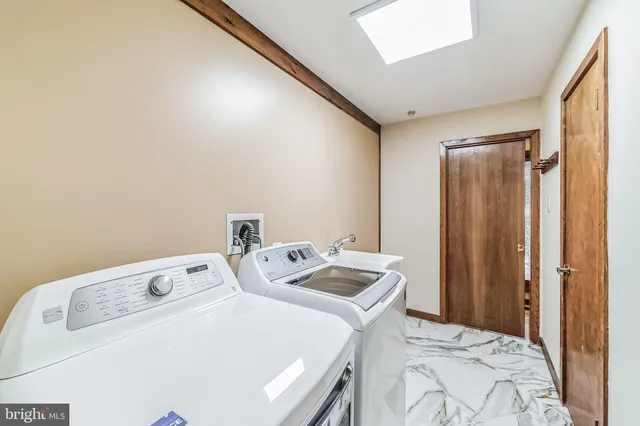 a bathroom with a sink a toilet a mirror and shower