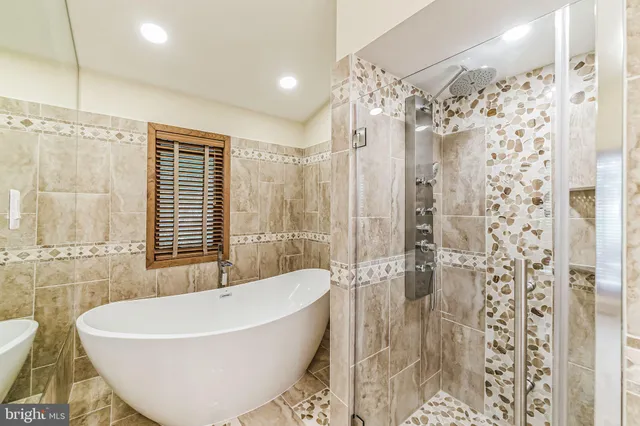 a bathroom with a bathtub and shower