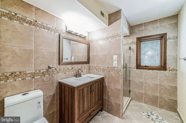 a bathroom with a shower and a sink