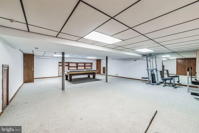 a room with pool table and windows
