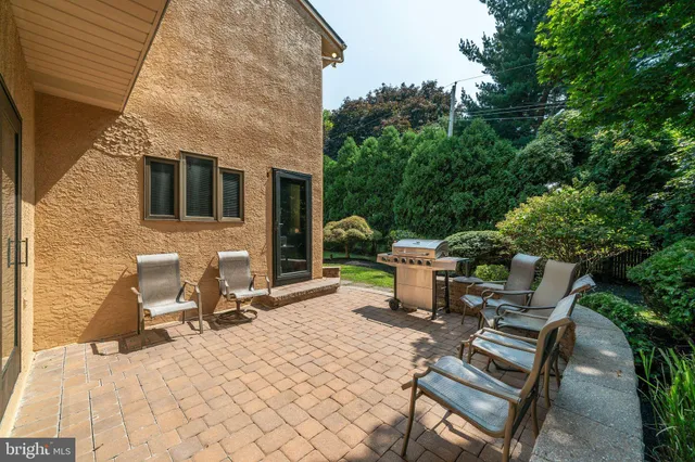a backyard of a house with a yard and outdoor seating