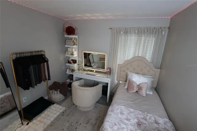 a living room with furniture a flat screen tv and rug