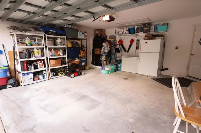 a view of a room with a chandelier fan