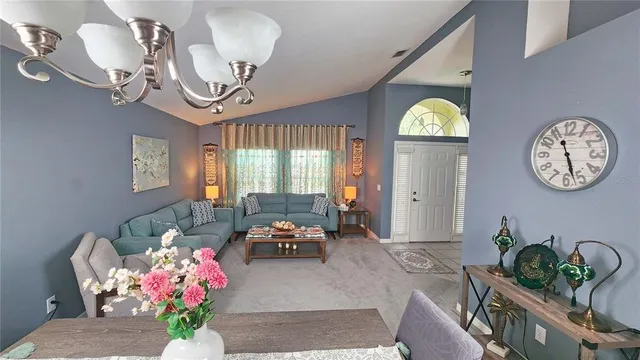 a living room with furniture and a lamp