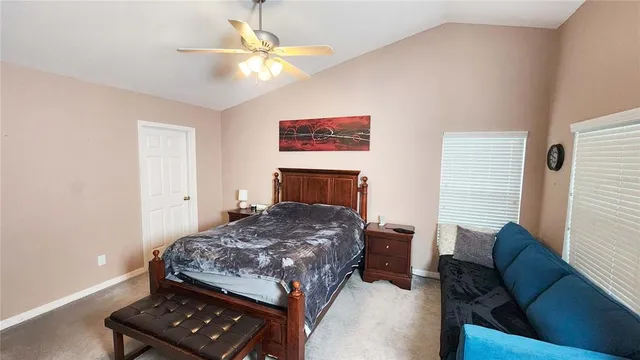 a bedroom with a bed and a couch