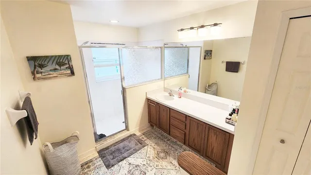 a bathroom with a sink a mirror and a shower