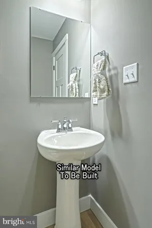 a bathroom with a sink a mirror and a toilet