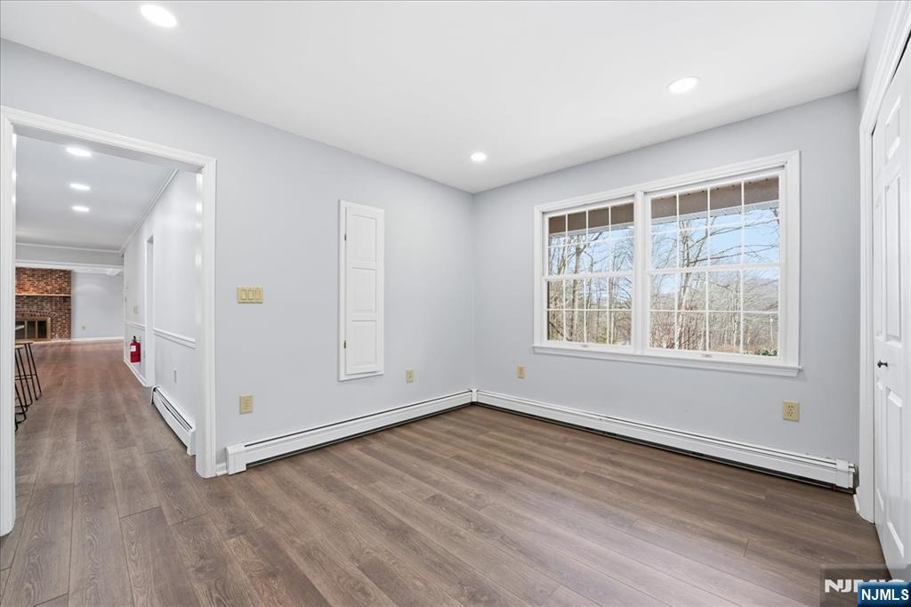 611 Snake Den Road West Milford, NJ 07480 - Photo 15 of 46 an empty room with wooden floor and windows