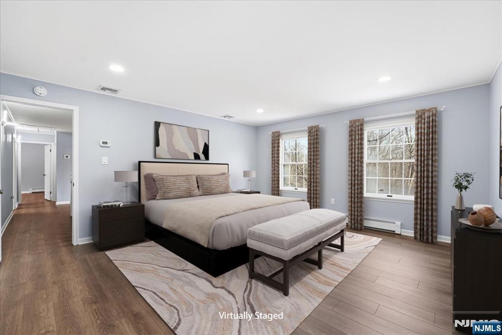 611 Snake Den Road West Milford, NJ 07480 - Photo 19 of 46 a bedroom with a large bed and wooden floor