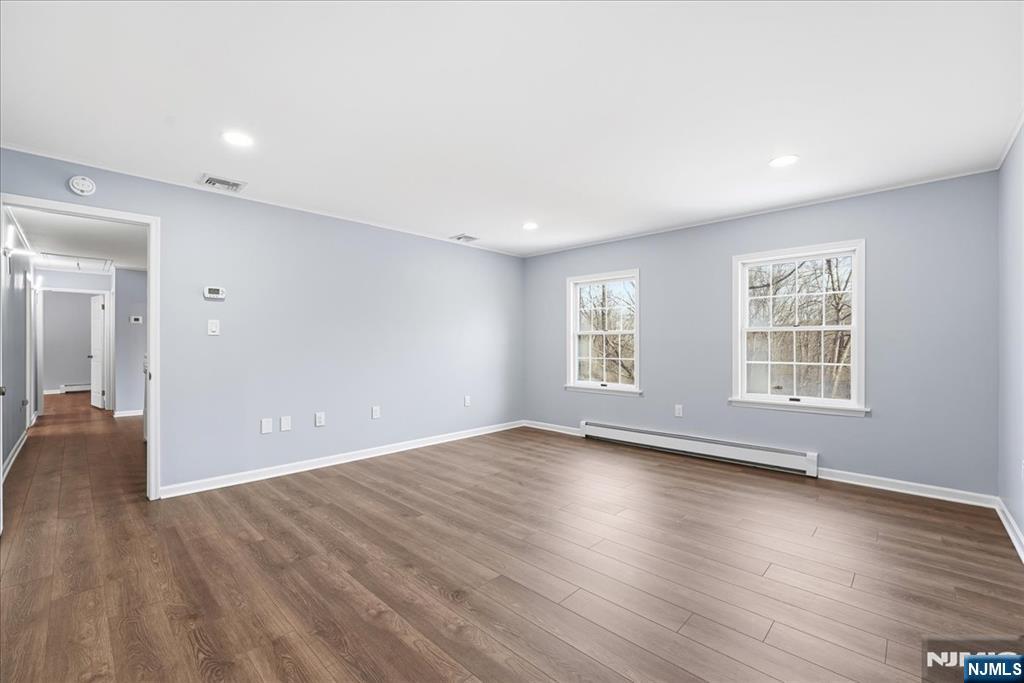 611 Snake Den Road West Milford, NJ 07480 - Photo 20 of 46 an empty room with wooden floor and windows