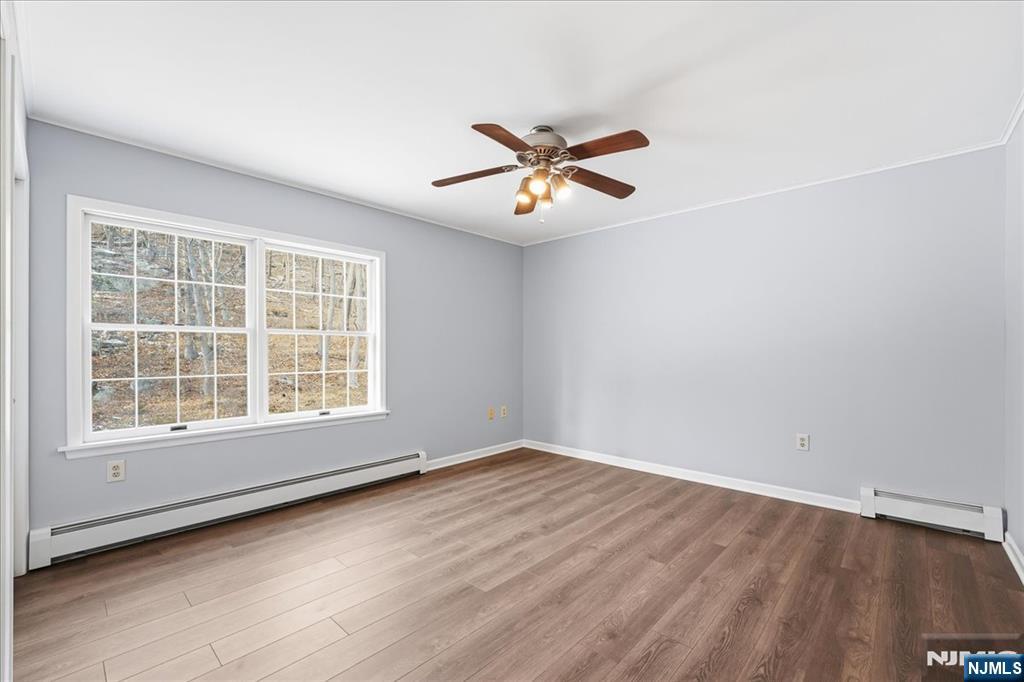 611 Snake Den Road West Milford, NJ 07480 - Photo 27 of 46 an empty room with wooden floor and windows