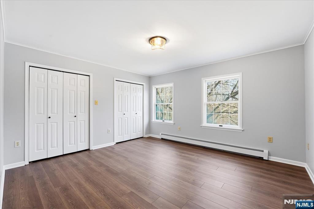 611 Snake Den Road West Milford, NJ 07480 - Photo 28 of 46 an empty room with wooden floor and windows