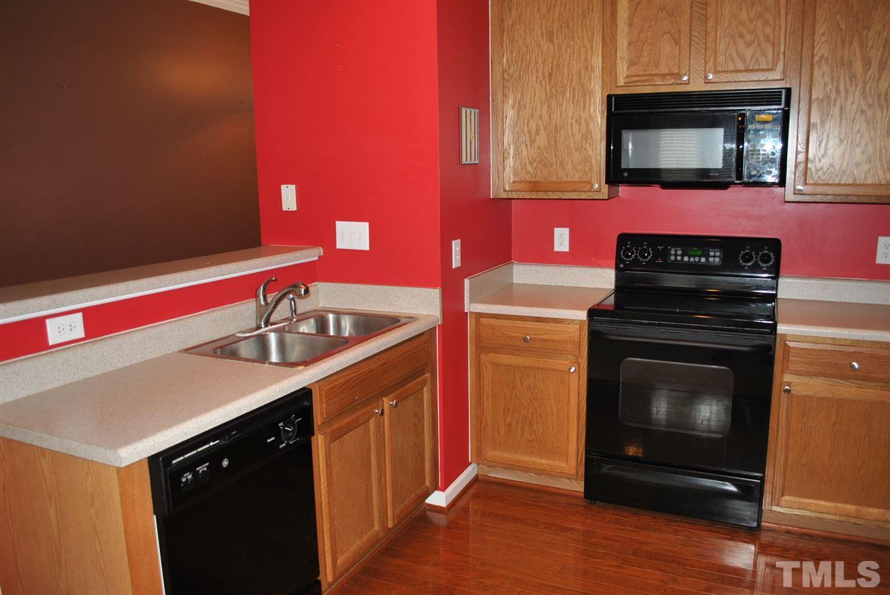 8234 Belneath Court Raleigh, NC 27613 - Photo 2 of 20 a kitchen with a sink and a stove top oven