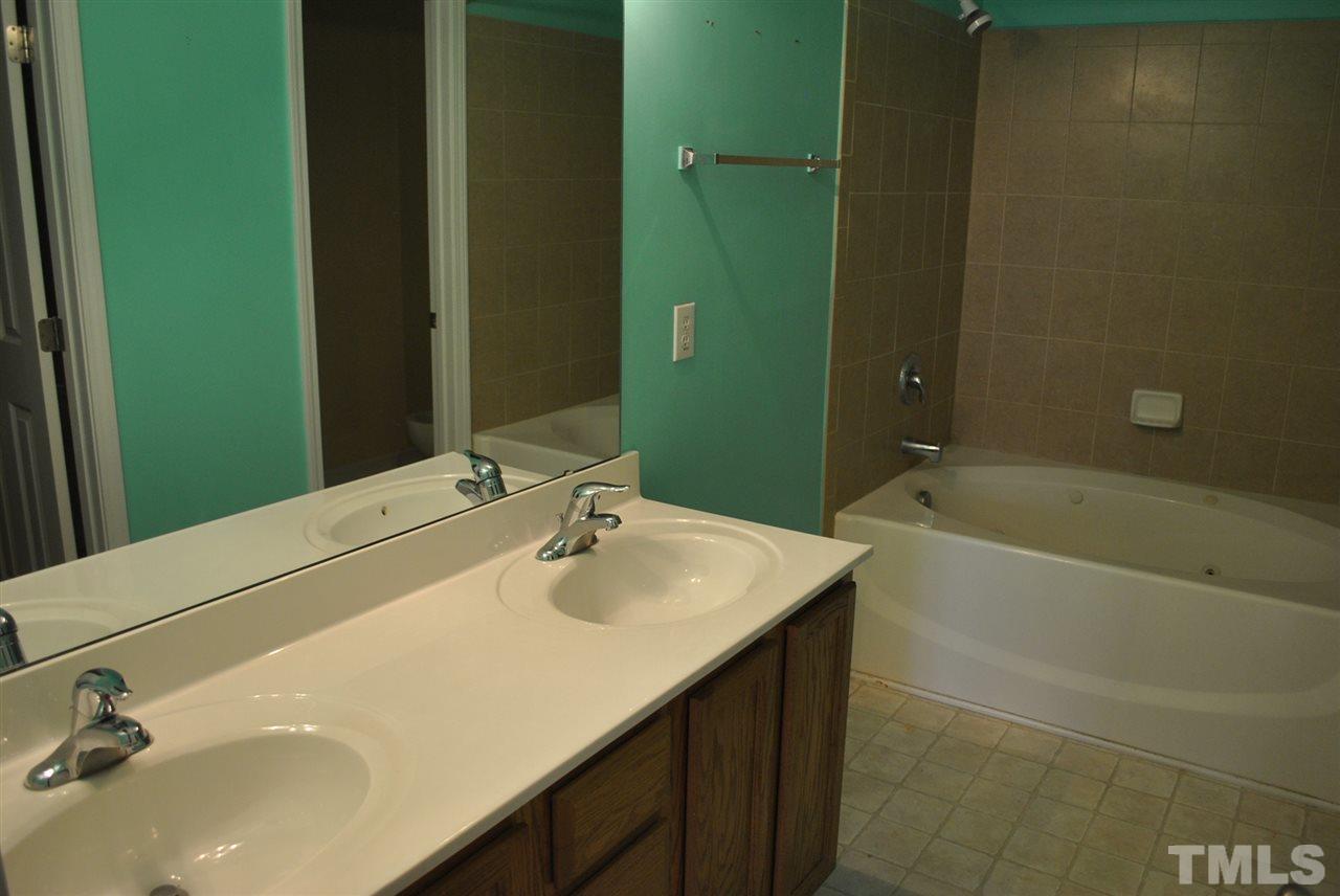 8234 Belneath Court Raleigh, NC 27613 - Photo 15 of 20 a bathroom with a sink and a mirror