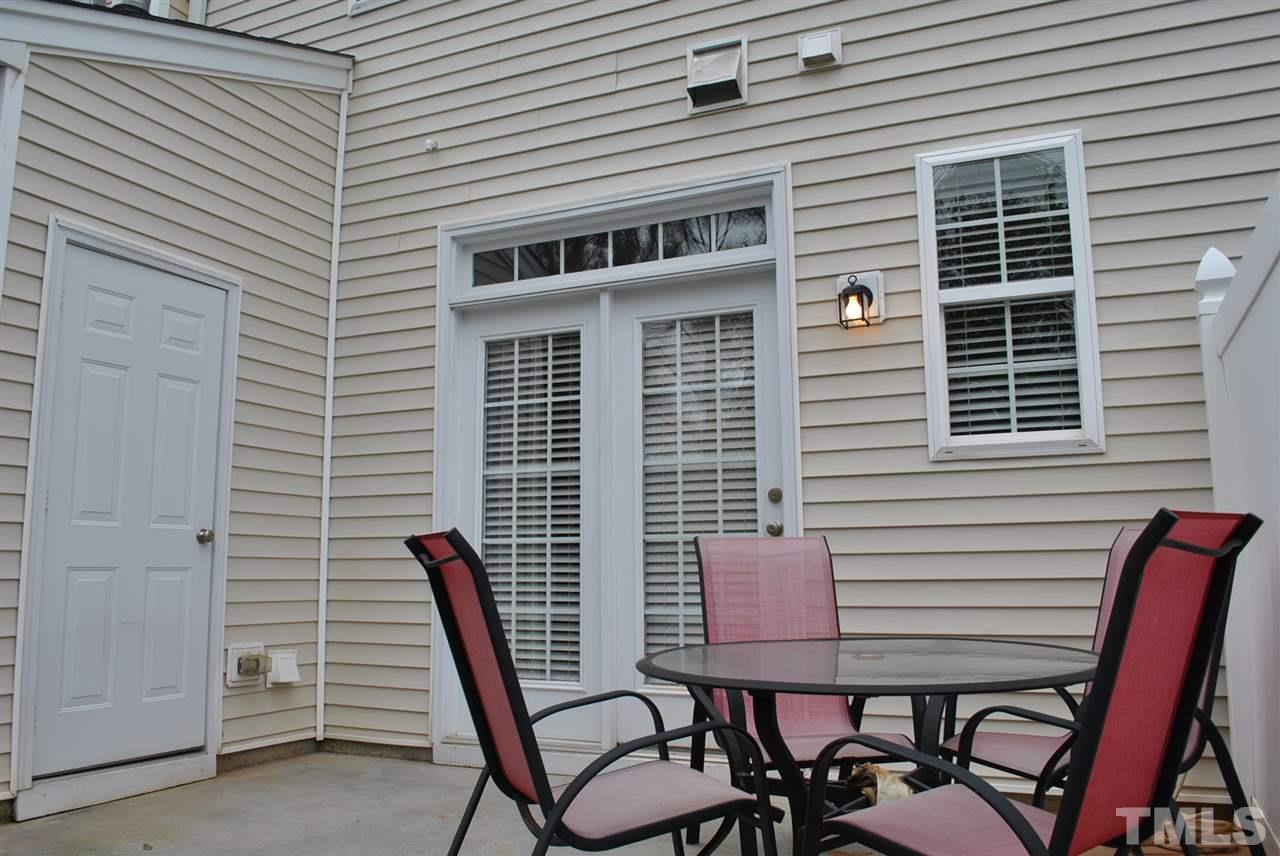 8234 Belneath Court Raleigh, NC 27613 - Photo 19 of 20 a view of a patio with a table and chairs