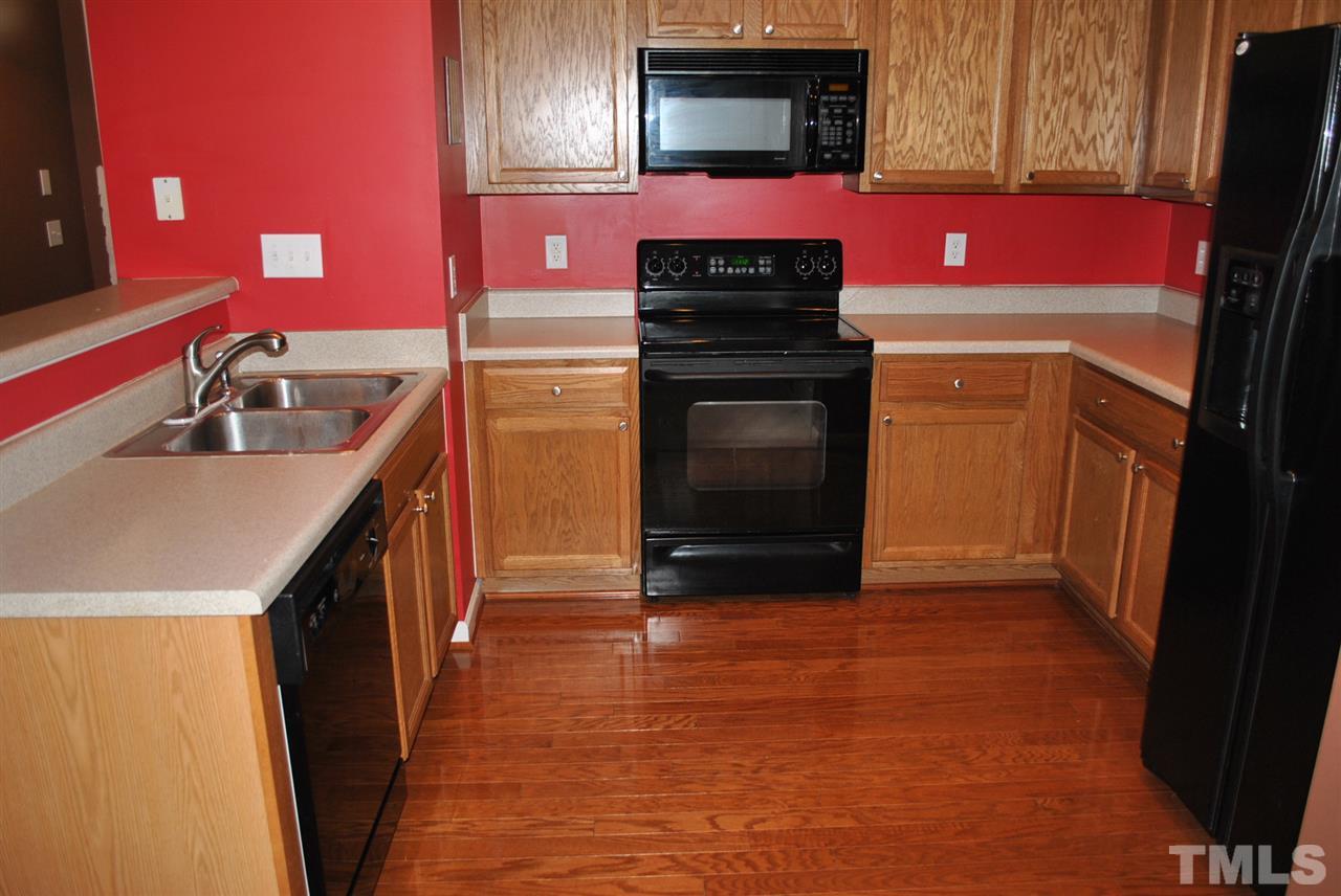 8234 Belneath Court Raleigh, NC 27613 - Photo 3 of 20 a kitchen with a sink stove and cabinets