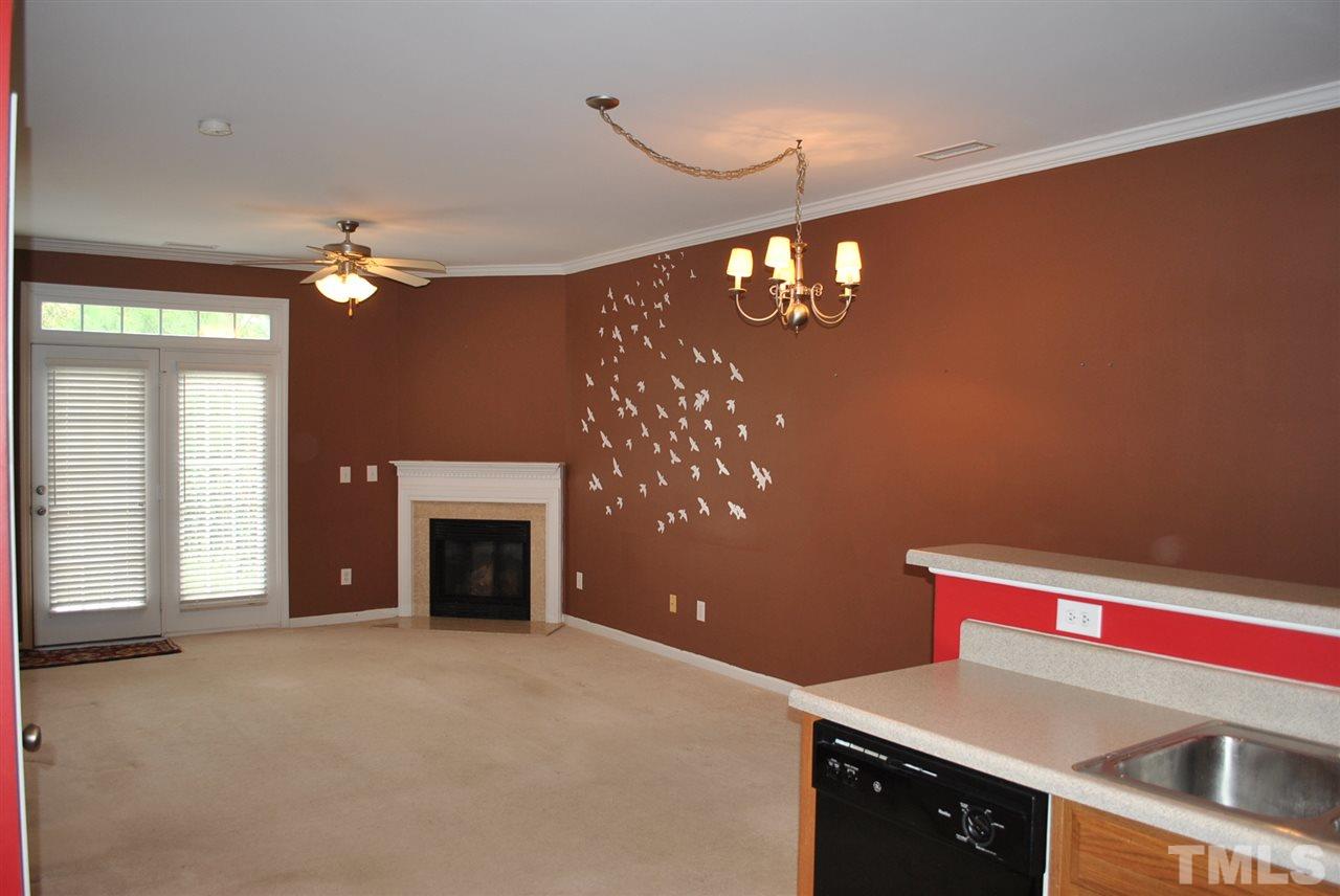 8234 Belneath Court Raleigh, NC 27613 - Photo 7 of 20 a view of an empty room with a fireplace and a window
