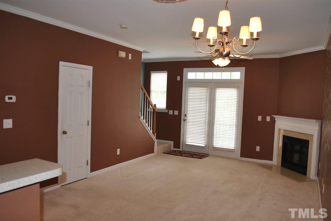 8234 Belneath Court Raleigh, NC 27613 - Photo 9 of 20 a view of a livingroom with a chandelier fan and windows