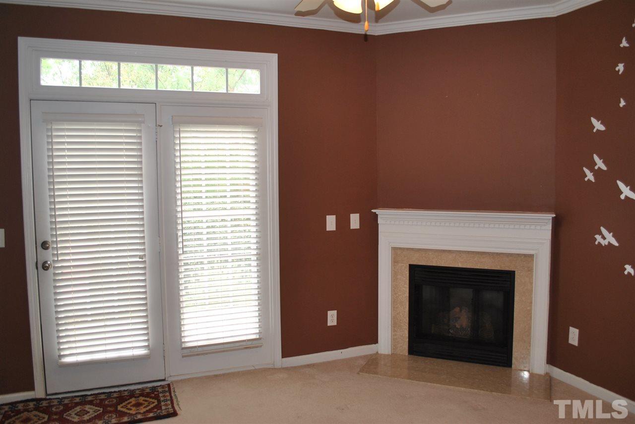 8234 Belneath Court Raleigh, NC 27613 - Photo 10 of 20 an empty room with windows and fireplace