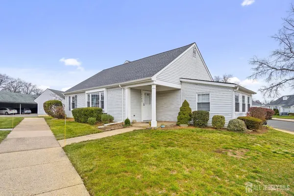 a front view of a house with a yard and porch