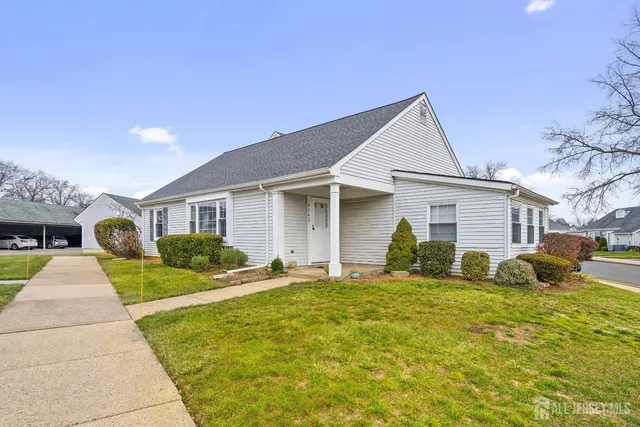 a front view of a house with a yard and porch