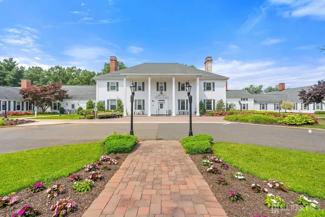 a front view of a house with garden