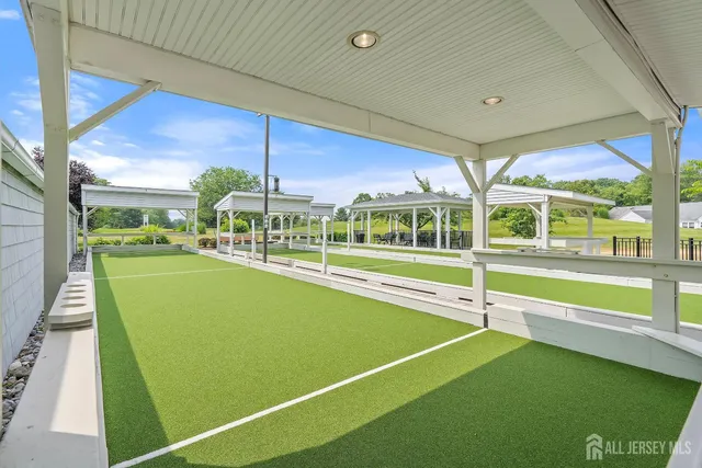 a view of a swimming pool with a lawn chairs under an umbrella