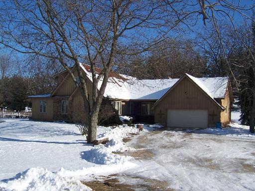14014 Davis Road Woodstock, IL 60098 - Photo 1 of 1 a front view of house with yard covered in snow