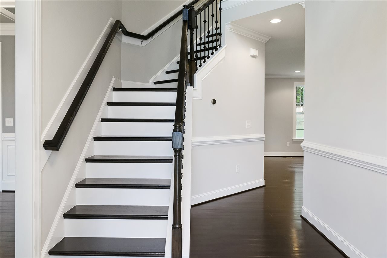 1405 Baxter Ridge Court Apex, NC 27502 - Photo 3 of 25 Gorgeous hardwood stairs and wrought iron spindles accent this dramatic foyer entrance hardwood staircase