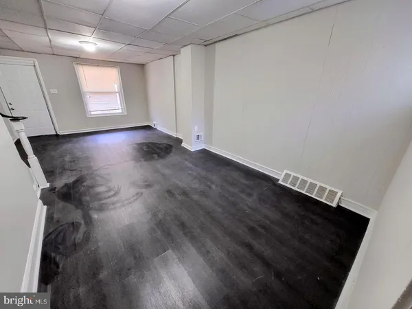 a view of room with window and hardwood floor
