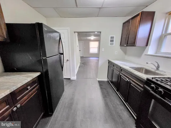 a kitchen with a refrigerator stove and sink