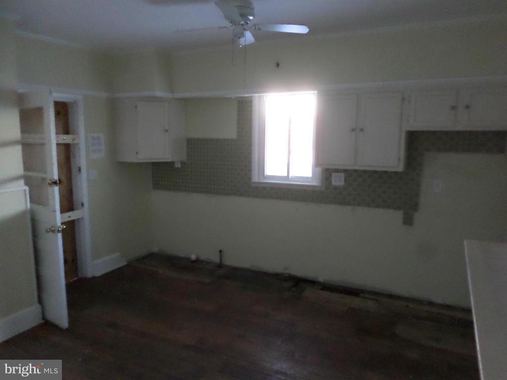 4534 Harford Road Baltimore, MD 21214 - Photo 8 of 18 an empty room with wooden floor and a window