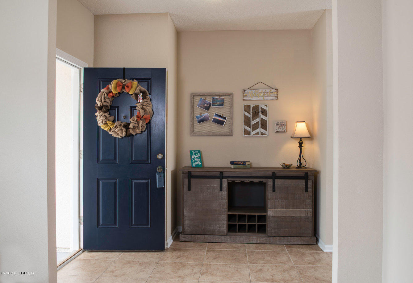 16365 Tisons Bluff Road Jacksonville, FL 32218 - Photo 1 of 25 a view of a hallway with paintings on the wall