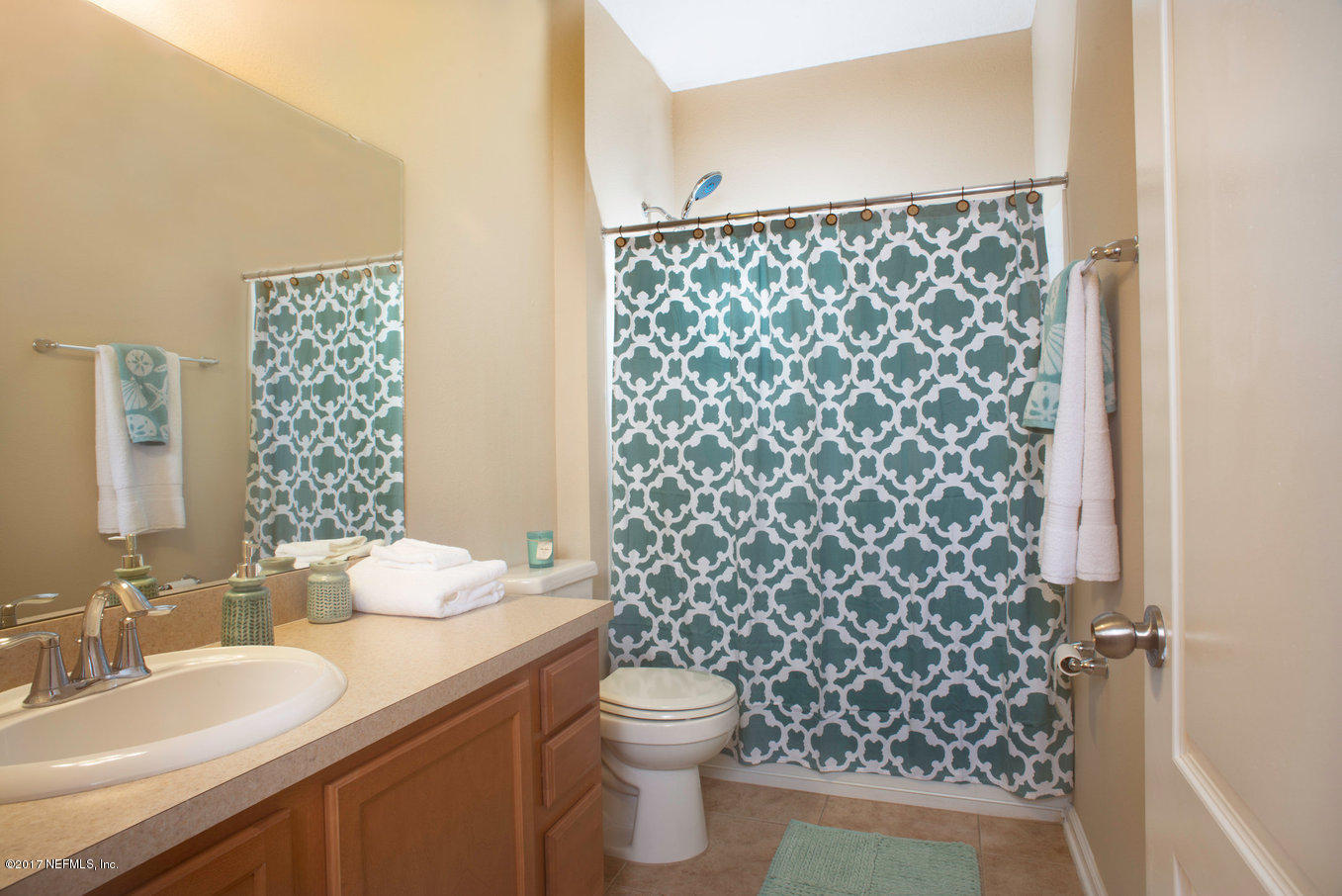 16365 Tisons Bluff Road Jacksonville, FL 32218 - Photo 14 of 25 a bathroom with a granite countertop sink a toilet and a mirror