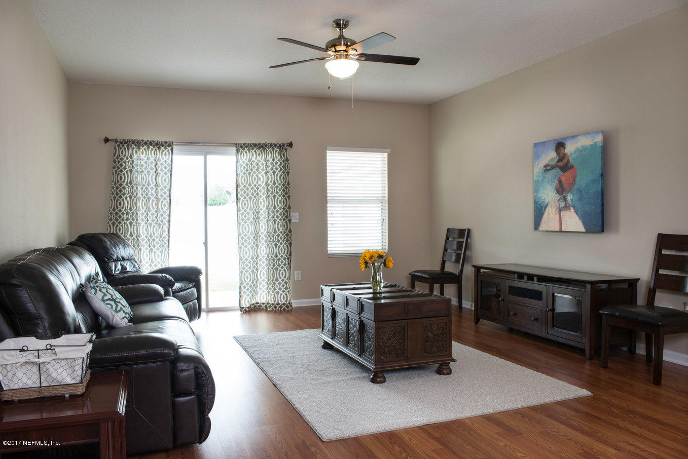 16365 Tisons Bluff Road Jacksonville, FL 32218 - Photo 3 of 25 a living room with furniture ceiling fan and a window