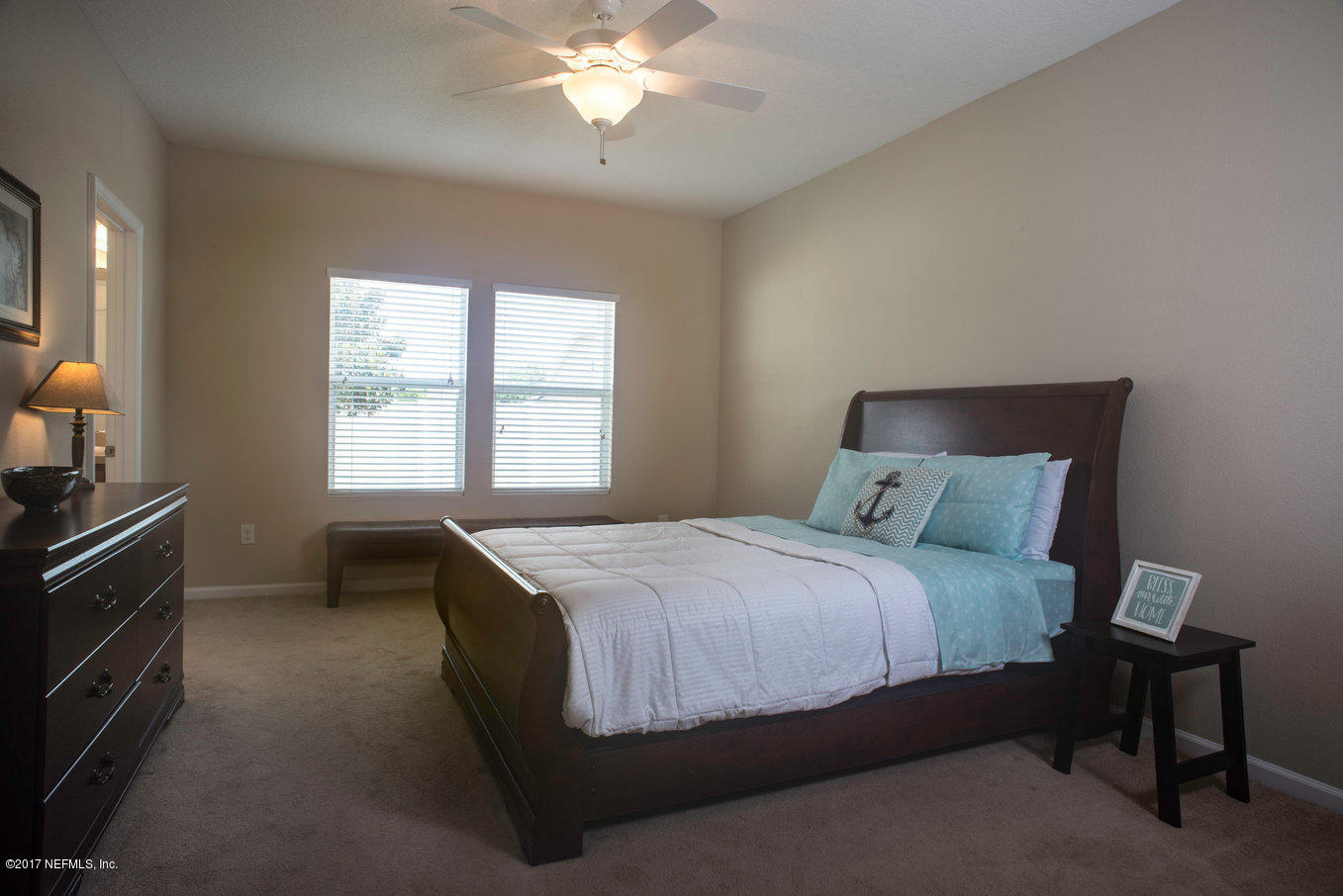 16365 Tisons Bluff Road Jacksonville, FL 32218 - Photo 7 of 25 a bedroom with a bed and a chandelier