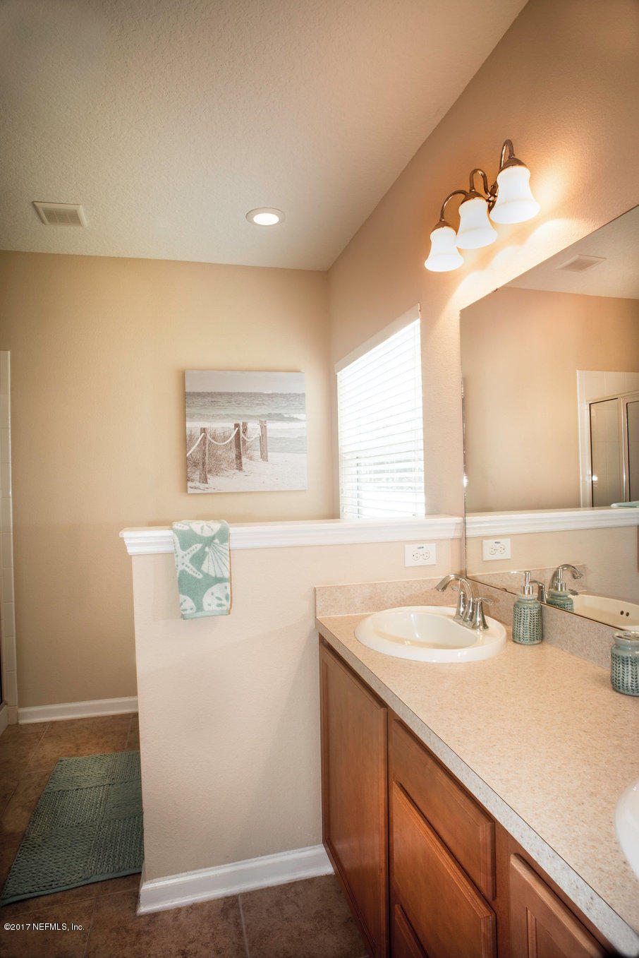 16365 Tisons Bluff Road Jacksonville, FL 32218 - Photo 9 of 25 a bathroom with a sink vanity and a mirror