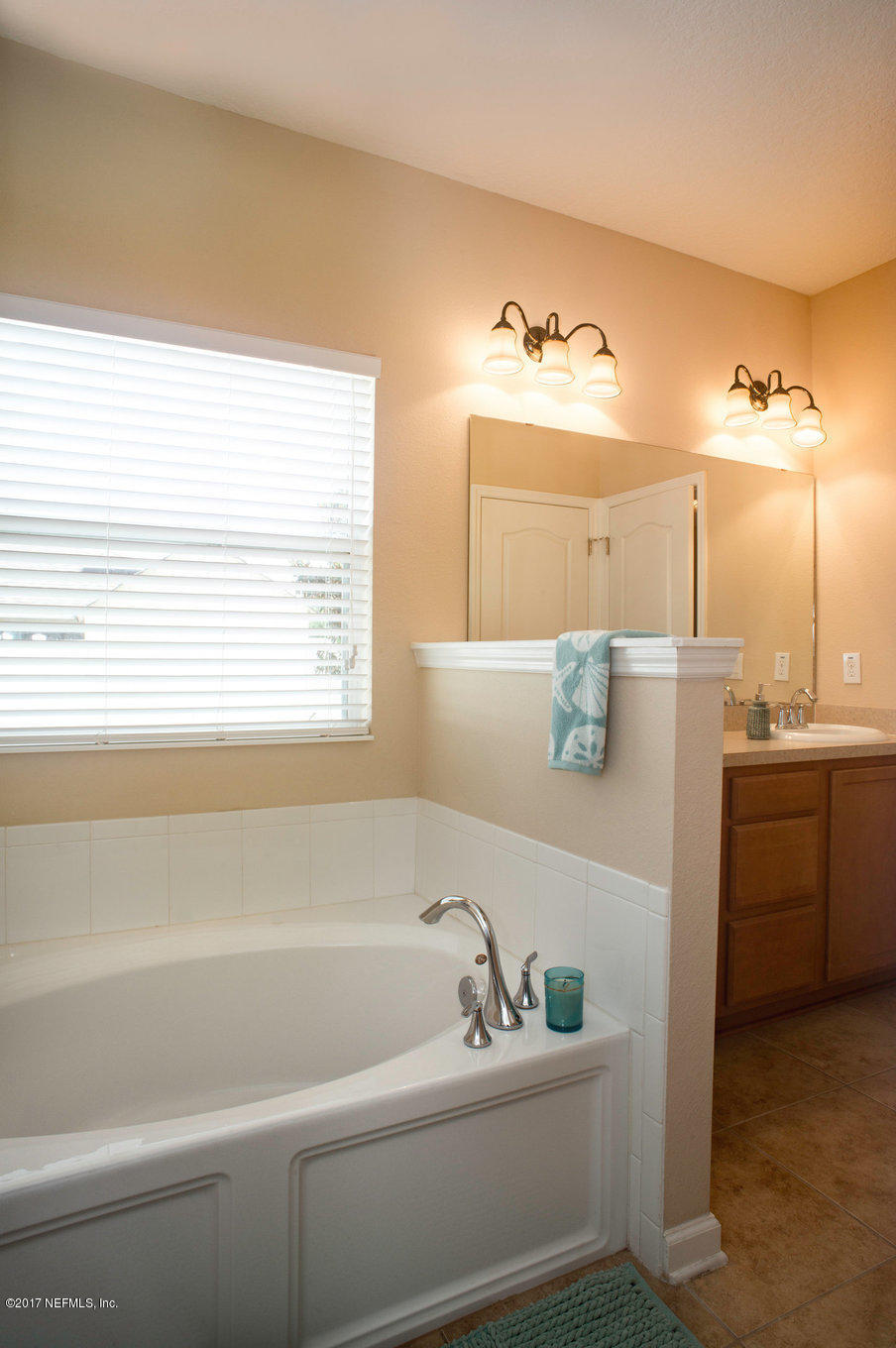 16365 Tisons Bluff Road Jacksonville, FL 32218 - Photo 10 of 25 a bathroom with a bathtub and a sink