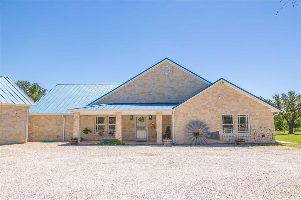 3612 Highway 1689 Comanche, TX 76442 - Photo 1 of 30 View of front facade featuring covered porch, a metal roof, and brick siding