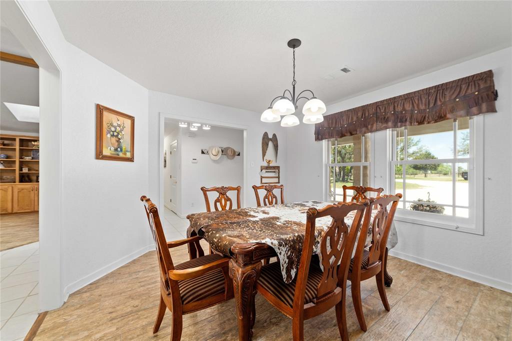 3612 Highway 1689 Comanche, TX 76442 - Photo 11 of 30 Dining space with light wood-style flooring and a chandelier