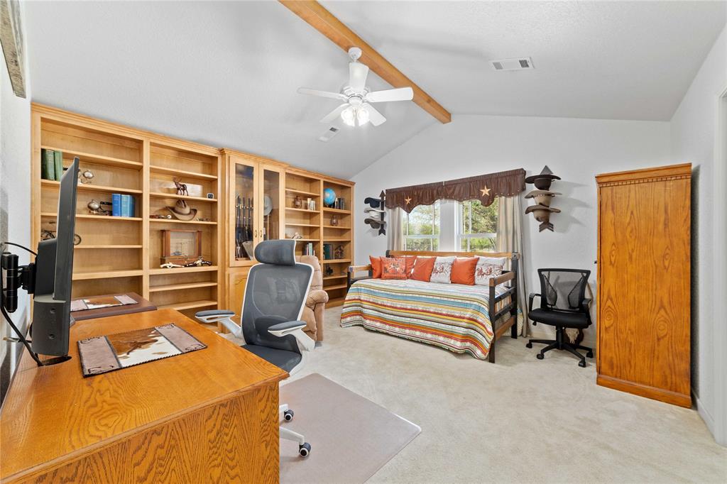 3612 Highway 1689 Comanche, TX 76442 - Photo 18 of 30 Bedroom featuring a desk, light colored carpet, and a ceiling fan