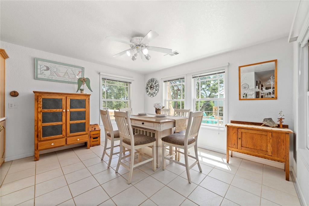 3612 Highway 1689 Comanche, TX 76442 - Photo 10 of 30 Dining area featuring light tile patterned floors, a ceiling fan, and a textured ceiling