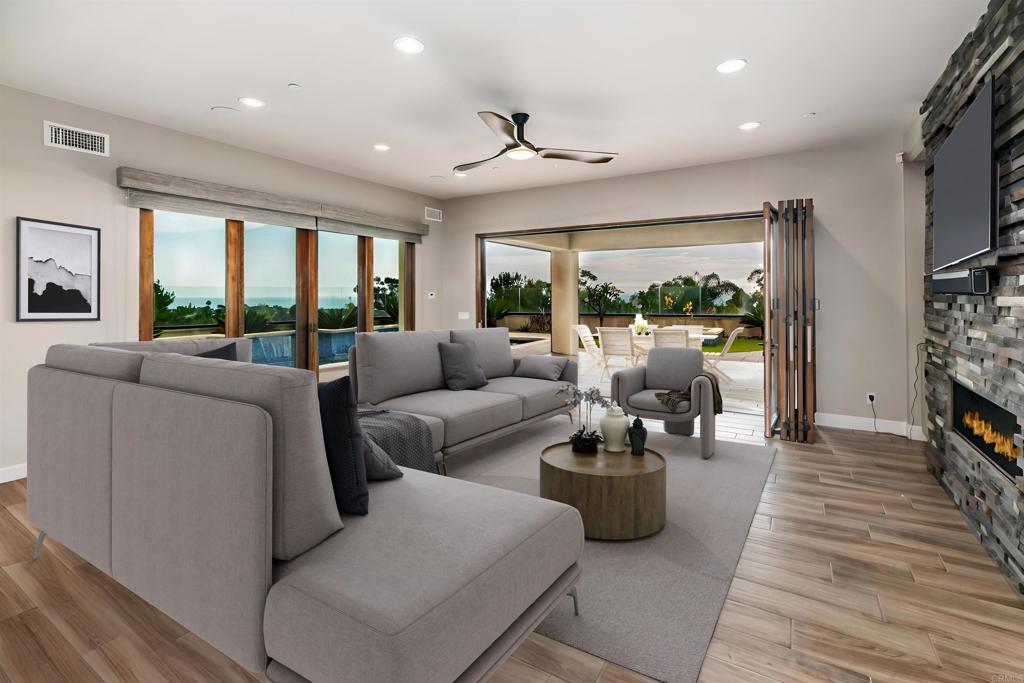 6768 Strawberry Place Carlsbad, CA 92011 - Photo 11 of 53 a living room with furniture and a flat screen tv