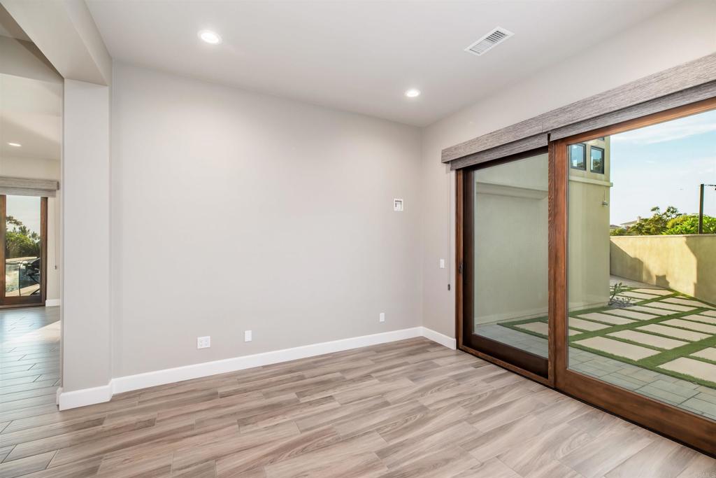 6768 Strawberry Place Carlsbad, CA 92011 - Photo 19 of 53 a view of a room with wooden floor