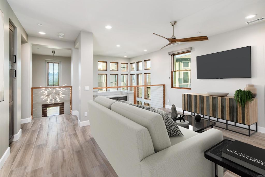 6768 Strawberry Place Carlsbad, CA 92011 - Photo 24 of 53 a living room with furniture and a flat screen tv